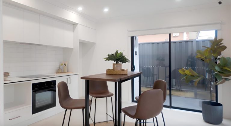 Kitchen and dining area with a high table at the Deer Park rooming house