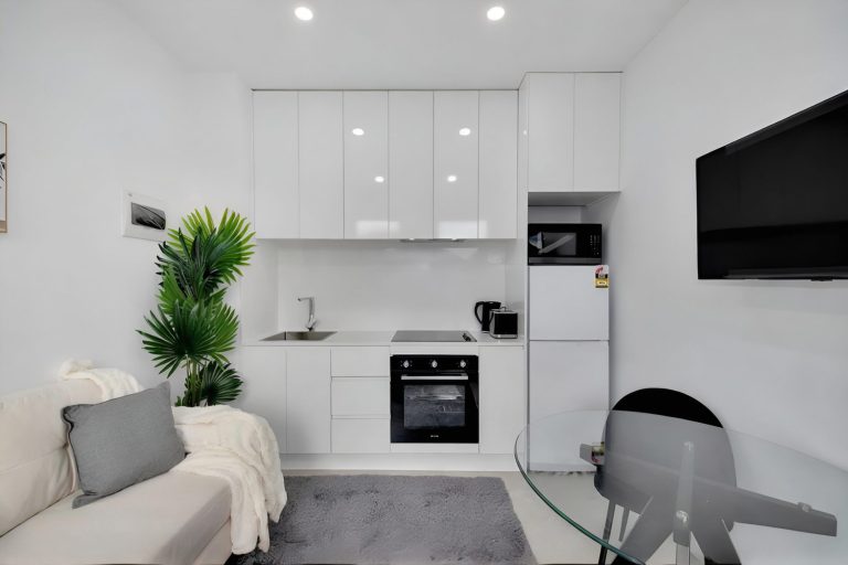 Kitchenette with oven, cooktop and fridge in a room at the Deer Park rooming house